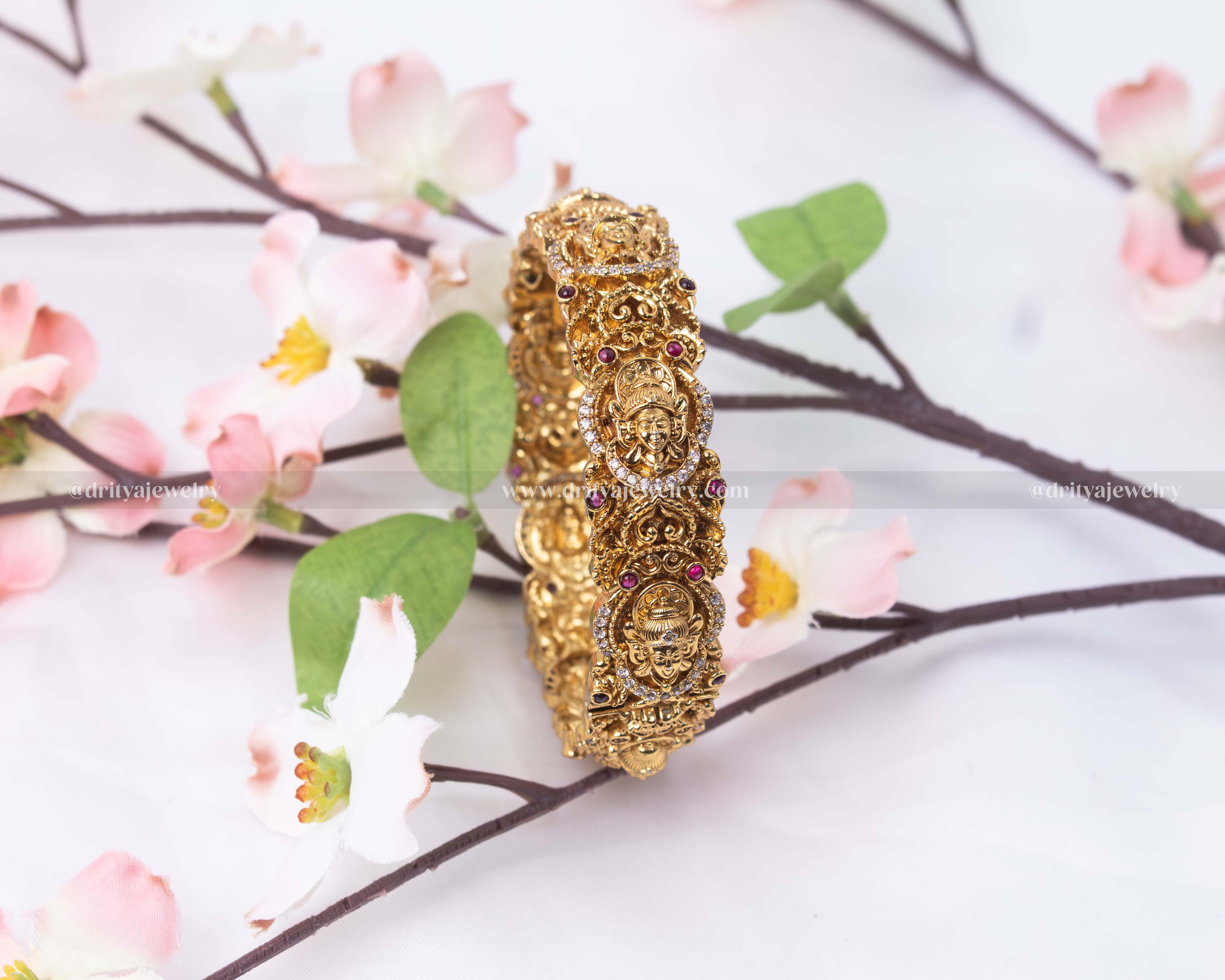 Showcase of the Regal Openable Temple Bangle with intricate Goddess motifs and gemstone embellishments by Dritya Jewelry.