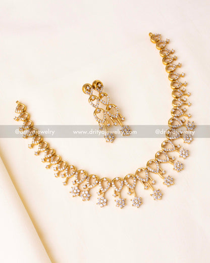 Exquisite gold-plated necklace set with shimmering CZ stones and delicate floral motifs.