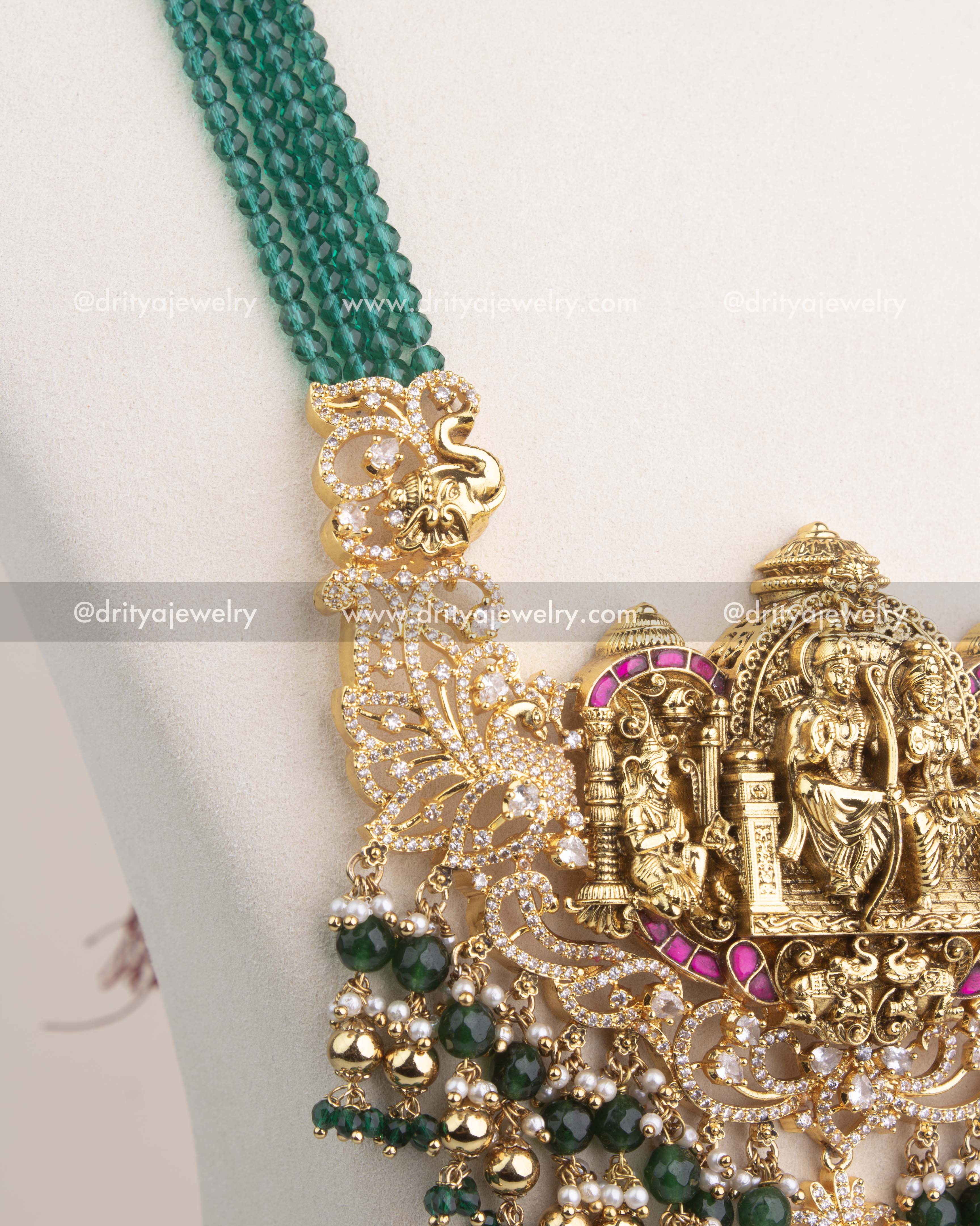 Multi-layer strands of green faceted beads attached to antique gold temple connectors.