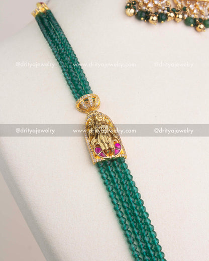 Multi-layer strands of green faceted beads attached to antique gold temple connectors.