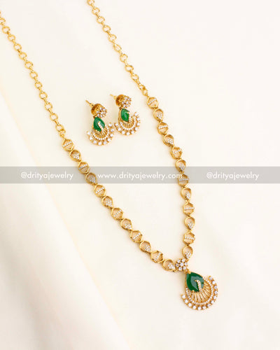 Green CZ Peacock Necklace Set with matching earrings on cream background