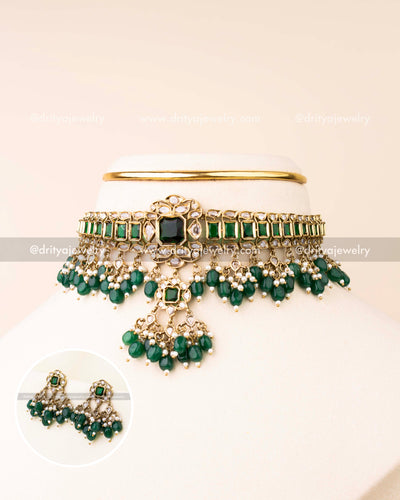 Premium choker necklace featuring green stones, reverse AD stones, and emerald bead drops with matching earrings.