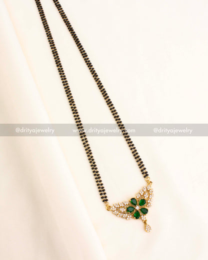 Double-strand black beads necklace with a green stone floral pendant and CZ accents.
