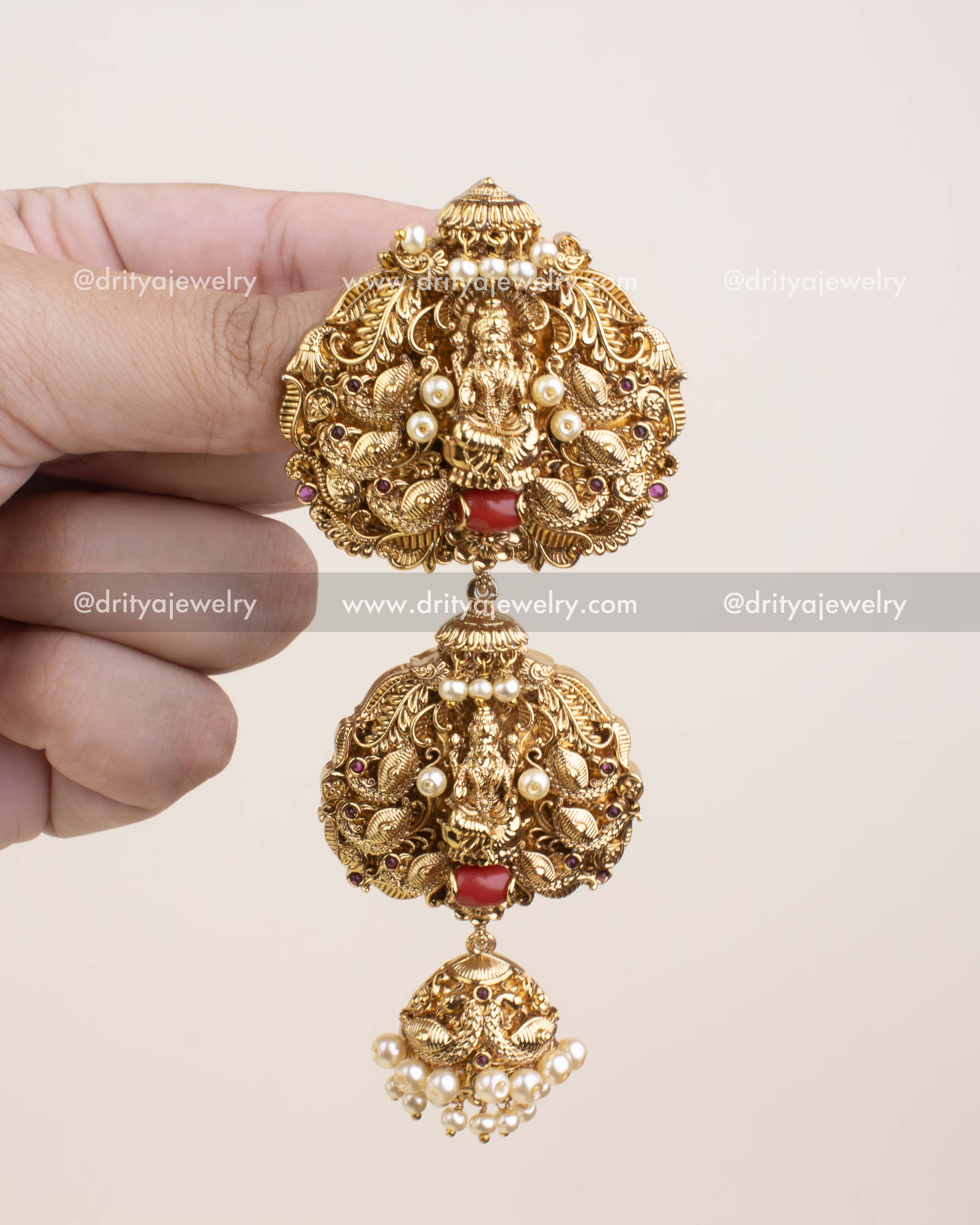 Real-size view of Nakshi Jada Billa showing intricate hand-carved details and pearl drops