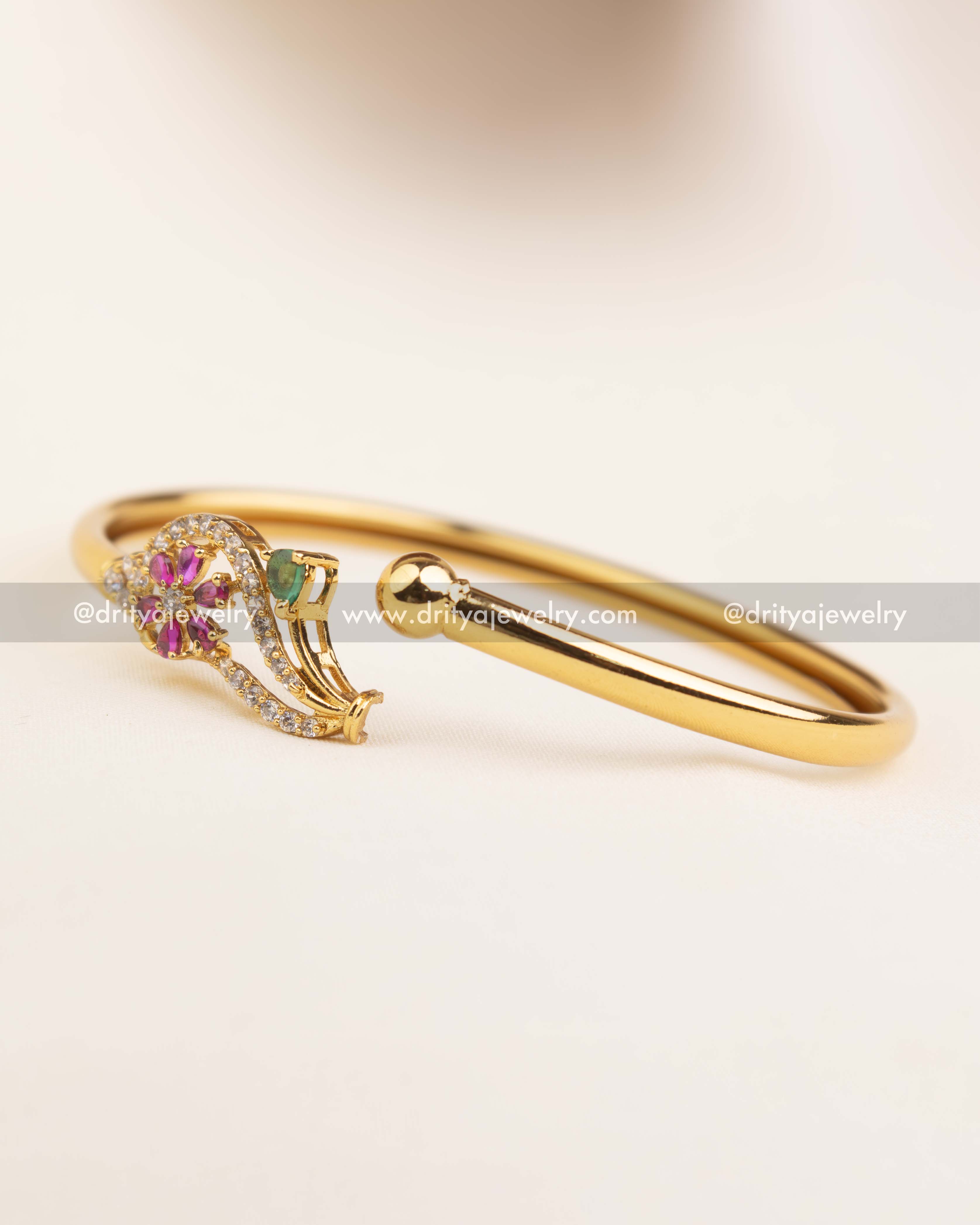 Close-up of locking mechanism and hinge on gold openable adjustable bangle