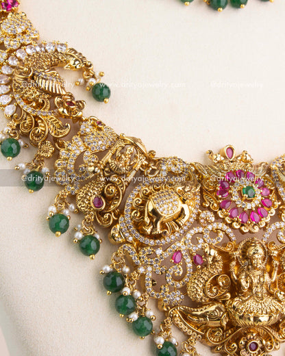 Close view of Nakshi temple jewelry chain with floral motifs, ruby stones, and CZ highlights.