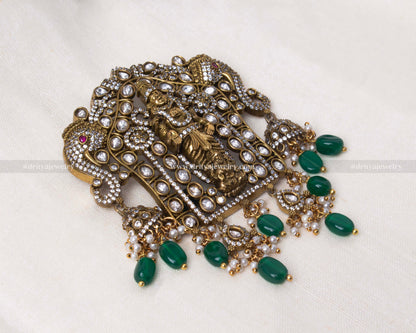 Close-up of the Venkateshwara Swamy pendant showcasing Victorian polish, kundan stones, and vibrant green bead detailing.