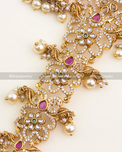 Detailed section showing intricate floral carvings, CZ stones, and colorful kundans.