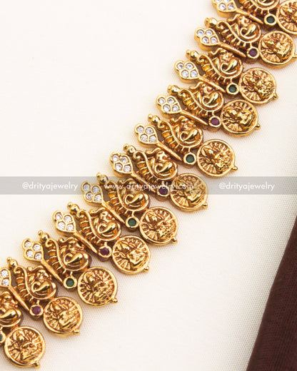 Close-up of ornate kasulu coin chain with antique gold temple finish.