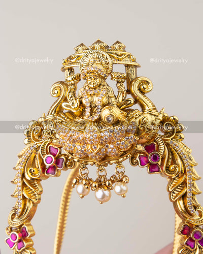 Close-up of Kemp temple vanki showing Lakshmi carving, crystal work, and pearl drops