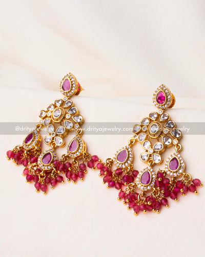 Elegant gold-plated Chandbali earrings featuring Kundan work, pink teardrop stones, and cascading pink crystal beads.