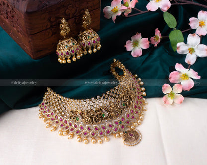 Full display of Dritya Jewelry's Lakshmi Devi Grandeur Choker Set with intricate carvings and gemstone embellishments.