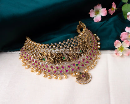 Full display of Dritya Jewelry's Lakshmi Devi Grandeur Choker Set with intricate carvings and gemstone embellishments.