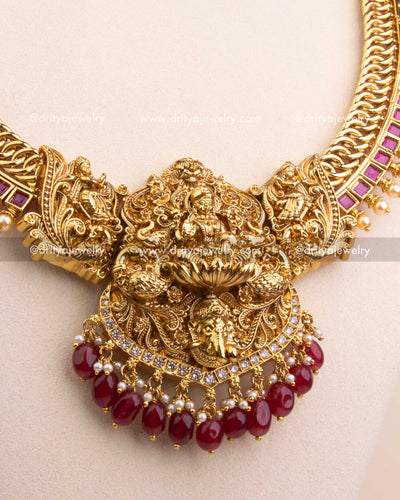 Ornate temple pendant featuring goddess design, AD stones, and ruby bead drops.