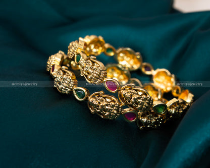 Exquisite Lakshmi Devi Temple Bangles from Dritya Jewelry, adorned with faux rubies and emeralds, capturing traditional Indian elegance and spirituality.