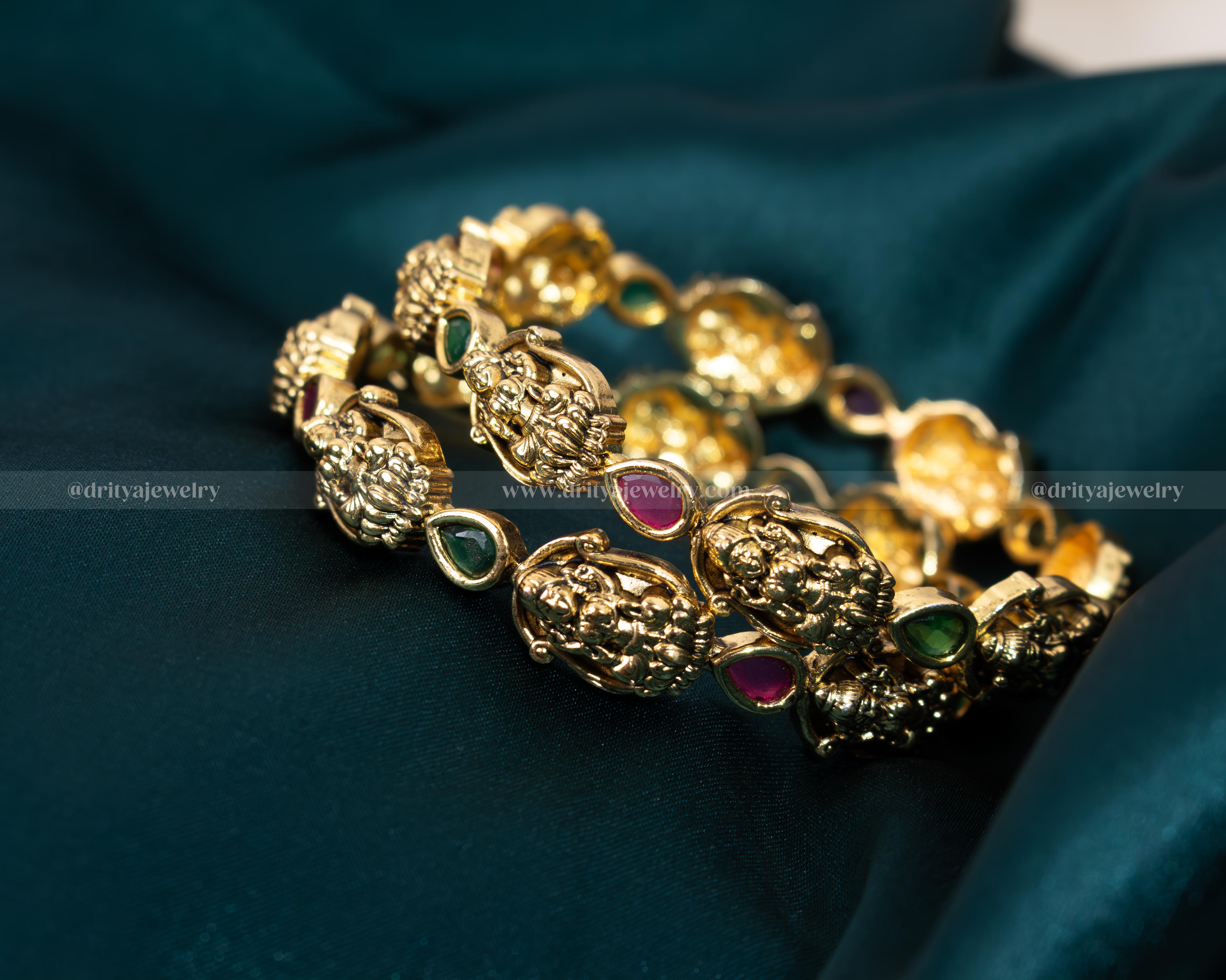 Exquisite Lakshmi Devi Temple Bangles from Dritya Jewelry, adorned with faux rubies and emeralds, capturing traditional Indian elegance and spirituality.