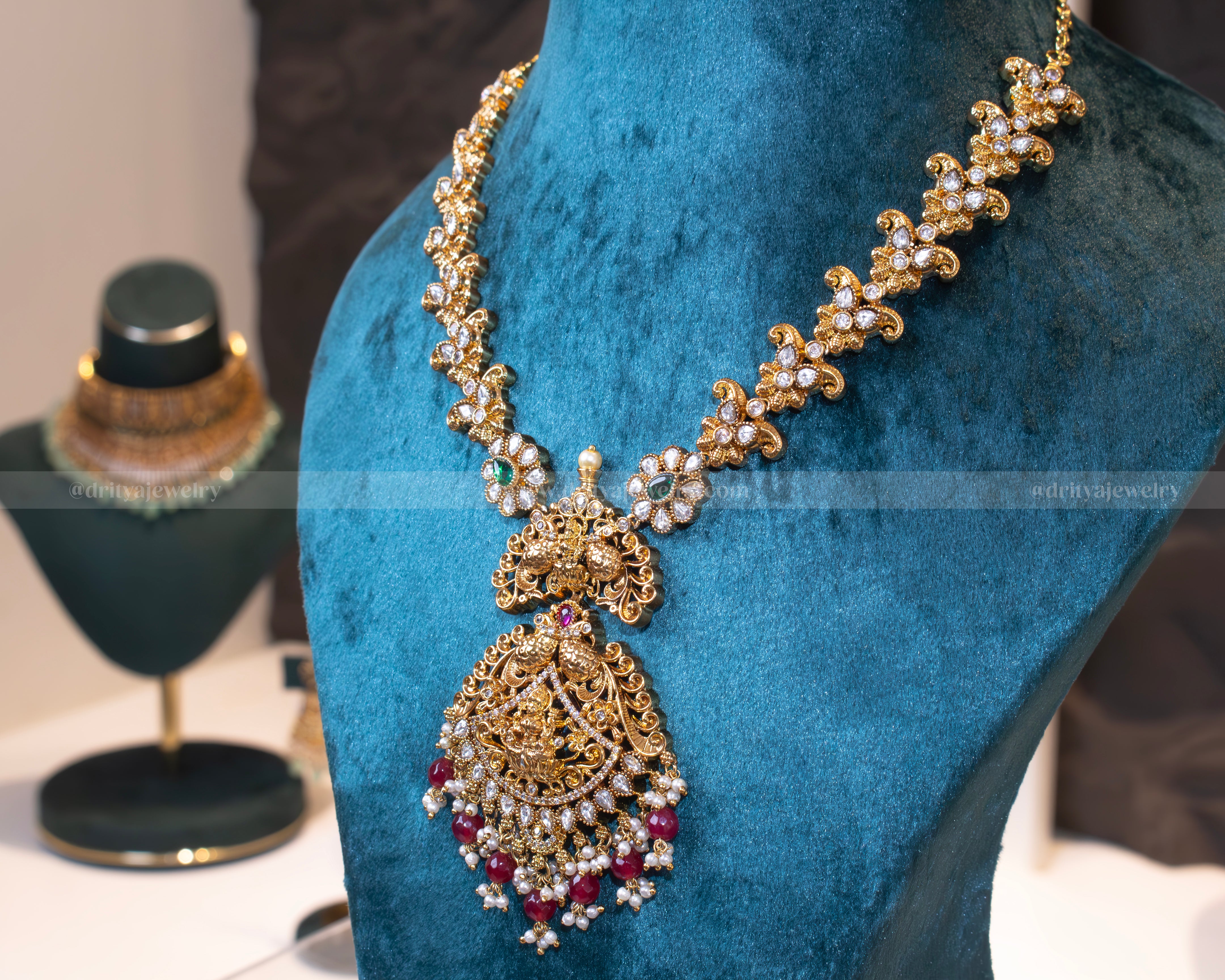 Side view of Dritya Jewelry's Lakshmi Devi Temple Necklace Set displaying the intricate design elements and gold-plated detailing.