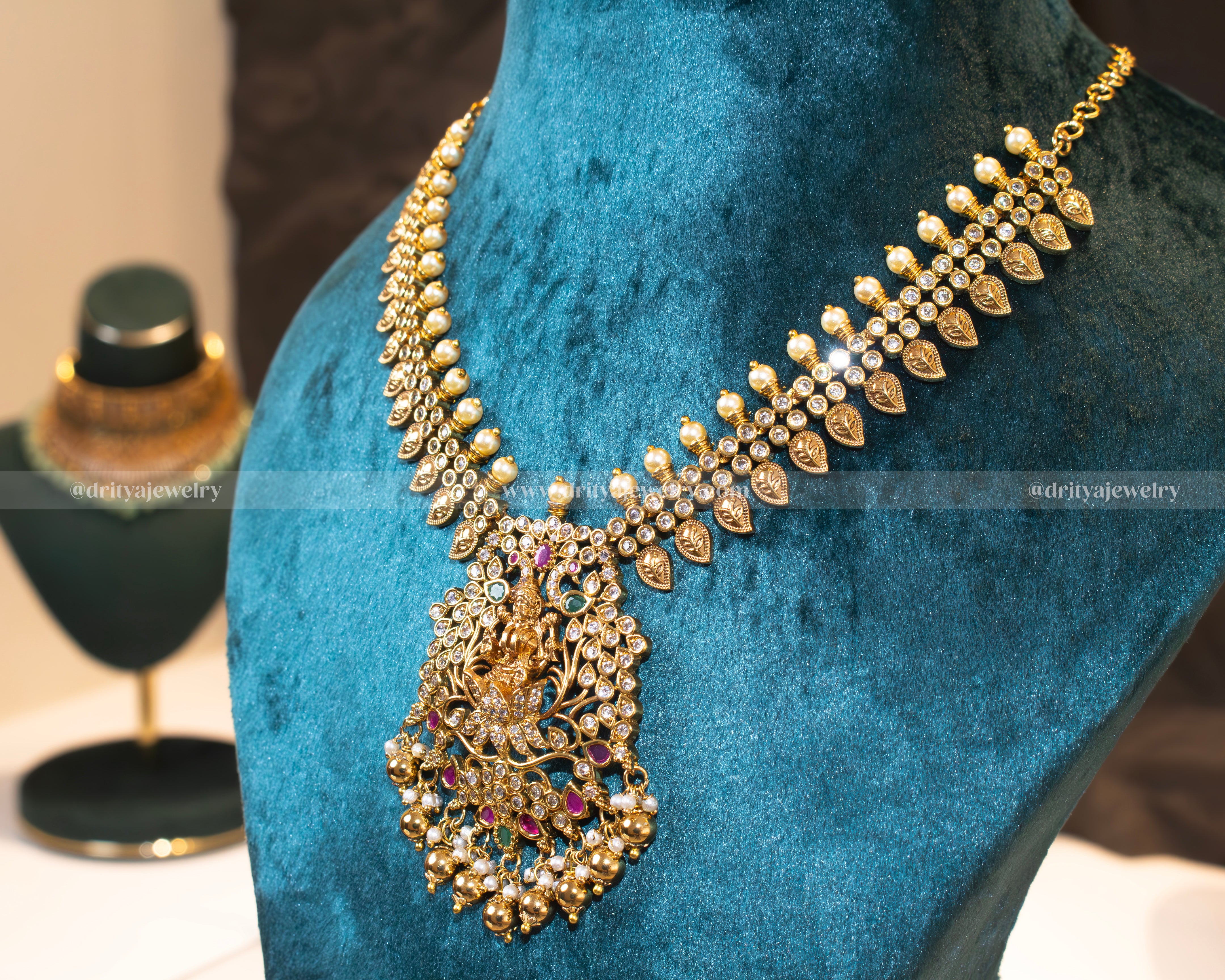 Lakshmi Devi Temple Necklace Set featuring a grand pendant, antique gold finish, and gemstone accents, perfect for bridal and festive occasions by Dritya Jewelry.