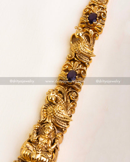 Close-up of antique-style gold chain design adorned with purple square stones and white CZ embellishments