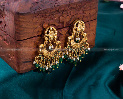 Close-up of the Lakshmi motif Chandbali earrings, showcasing detailed craftsmanship and gemstone embellishments by Dritya Jewelry.