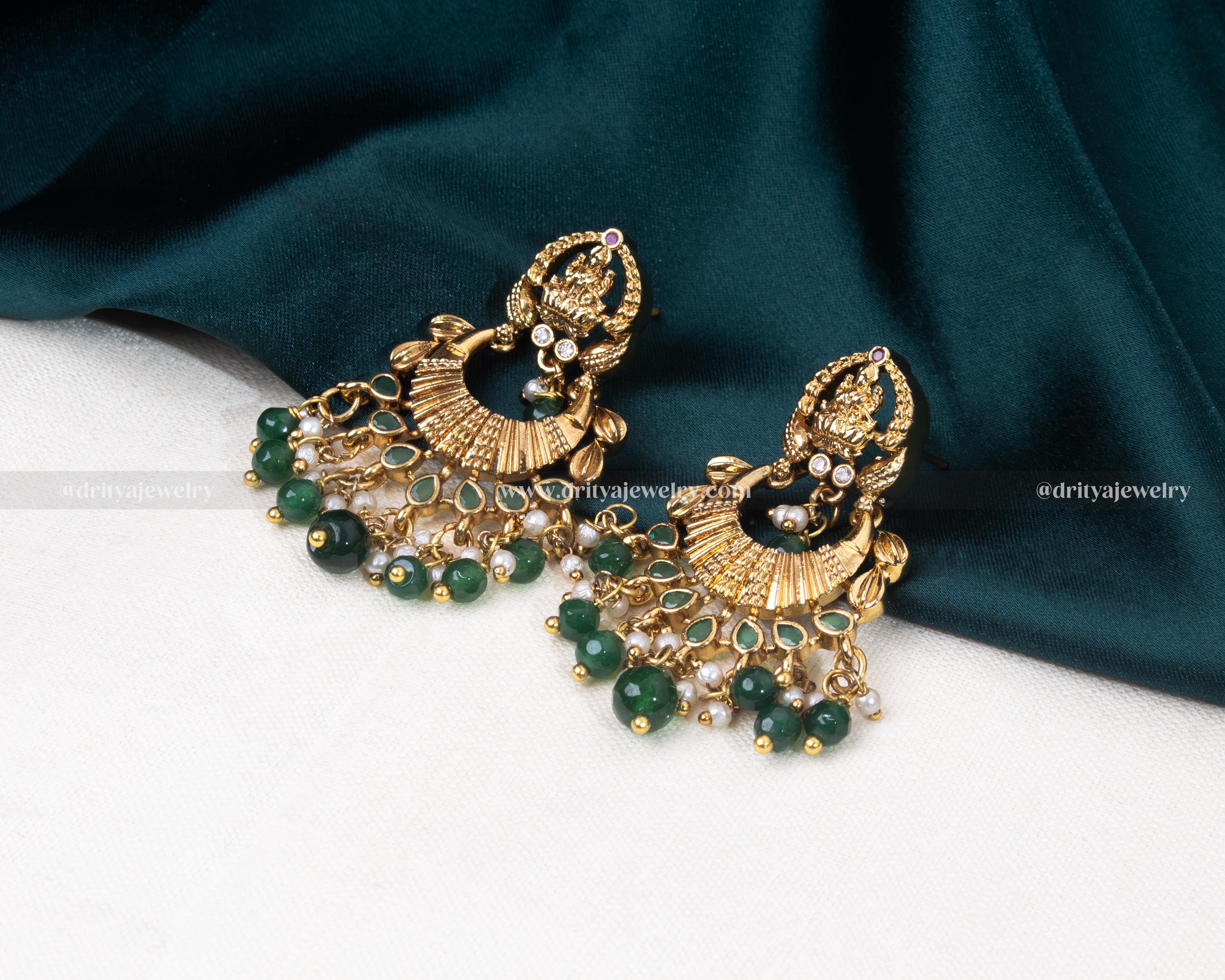 Close-up of the Lakshmi motif Chandbali earrings, showcasing detailed craftsmanship and gemstone embellishments by Dritya Jewelry.