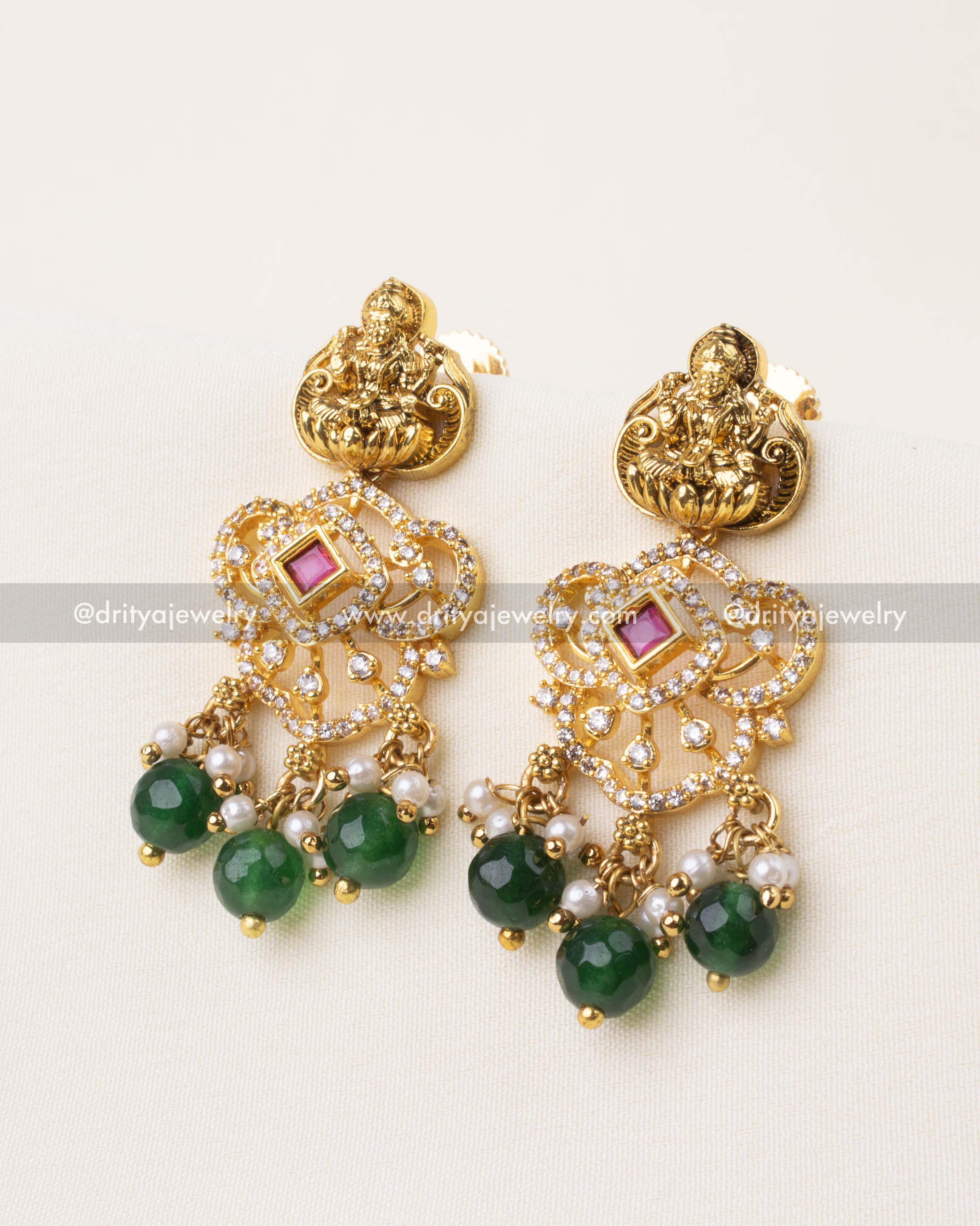 Green beaded gold earrings featuring Lakshmi stud, ruby center CZ, and pearl drops.