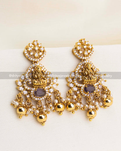 Temple-inspired earrings with Lakshmi motif, CZ stones, pearls, and gold bead drops.