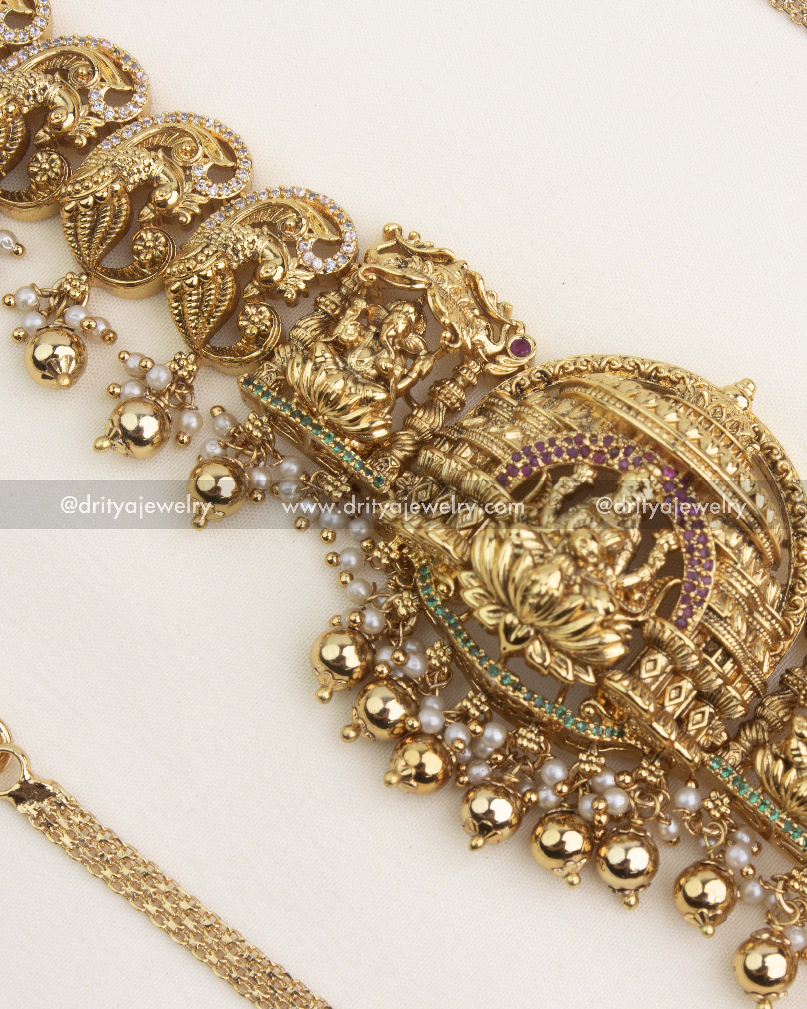 Temple-style Lakshmi pendant with antique finish and gold bead drops.