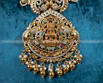 Close-up of Dritya Jewelry's Lakshmi Temple Necklace Set highlighting the detailed craftsmanship of the Lakshmi pendant and gold-plated intricacies.