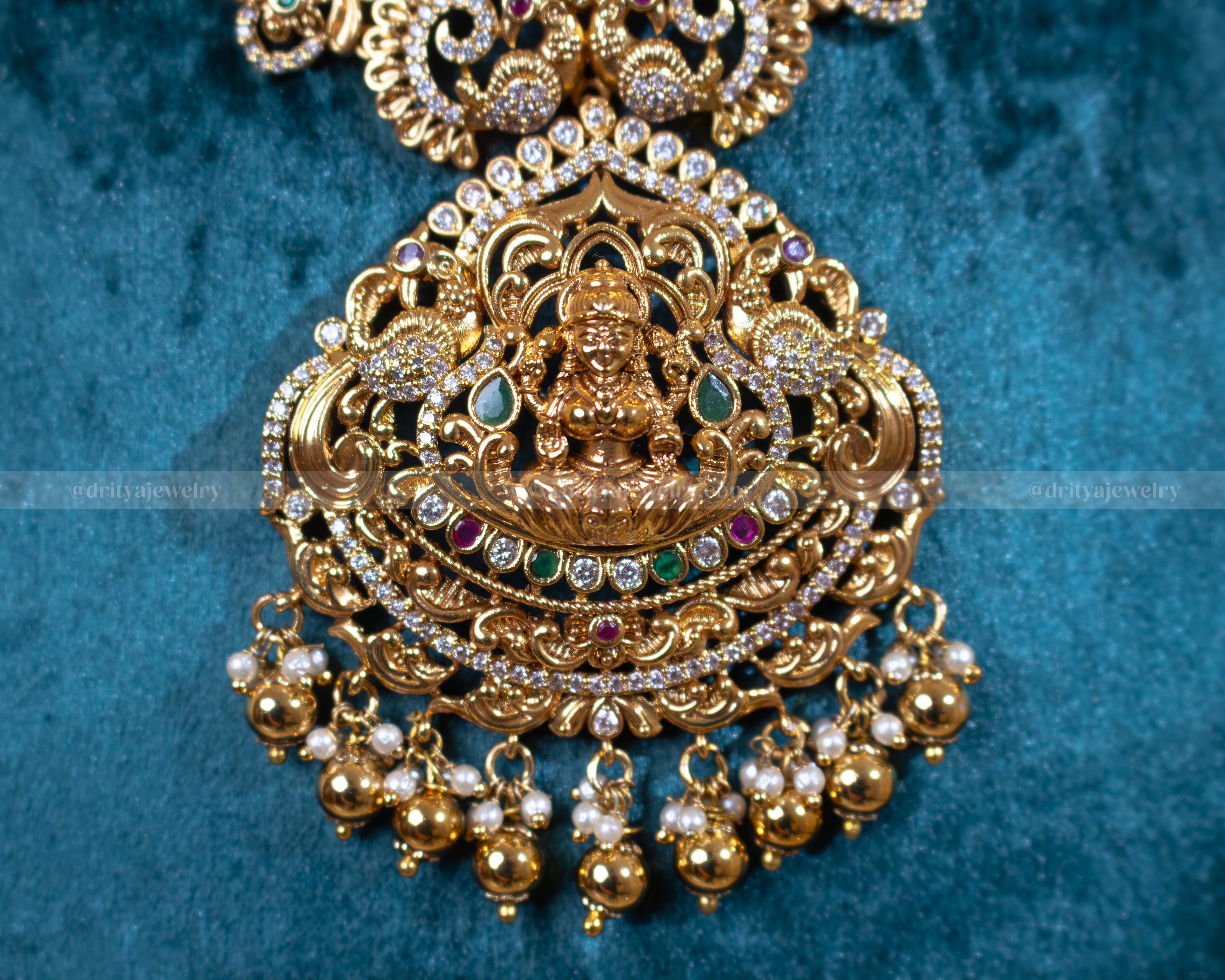 Close-up of Dritya Jewelry's Lakshmi Temple Necklace Set highlighting the detailed craftsmanship of the Lakshmi pendant and gold-plated intricacies.