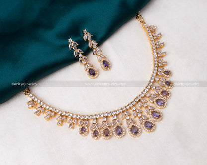 Elegant gold-tone necklace set with purple stones and sparkling CZ, ideal for special occasions.