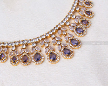 Elegant gold-tone necklace set with purple stones and sparkling CZ, ideal for special occasions.