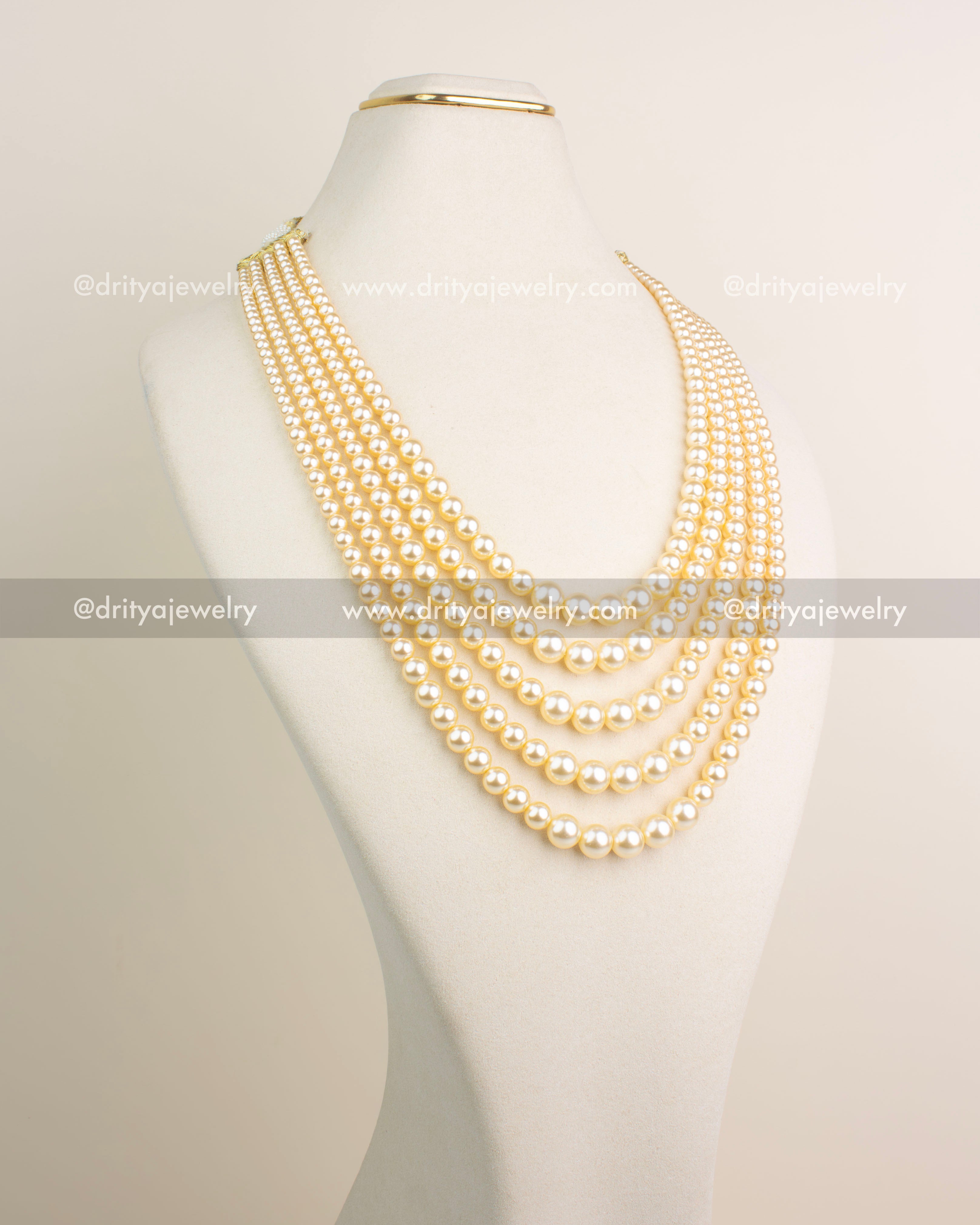Premium multi-layer imitation pearl maala with gold-toned finish and radiant bead strands.
