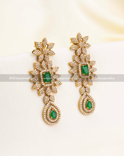 Matching floral earrings with CZ stones and emerald green teardrop accents.