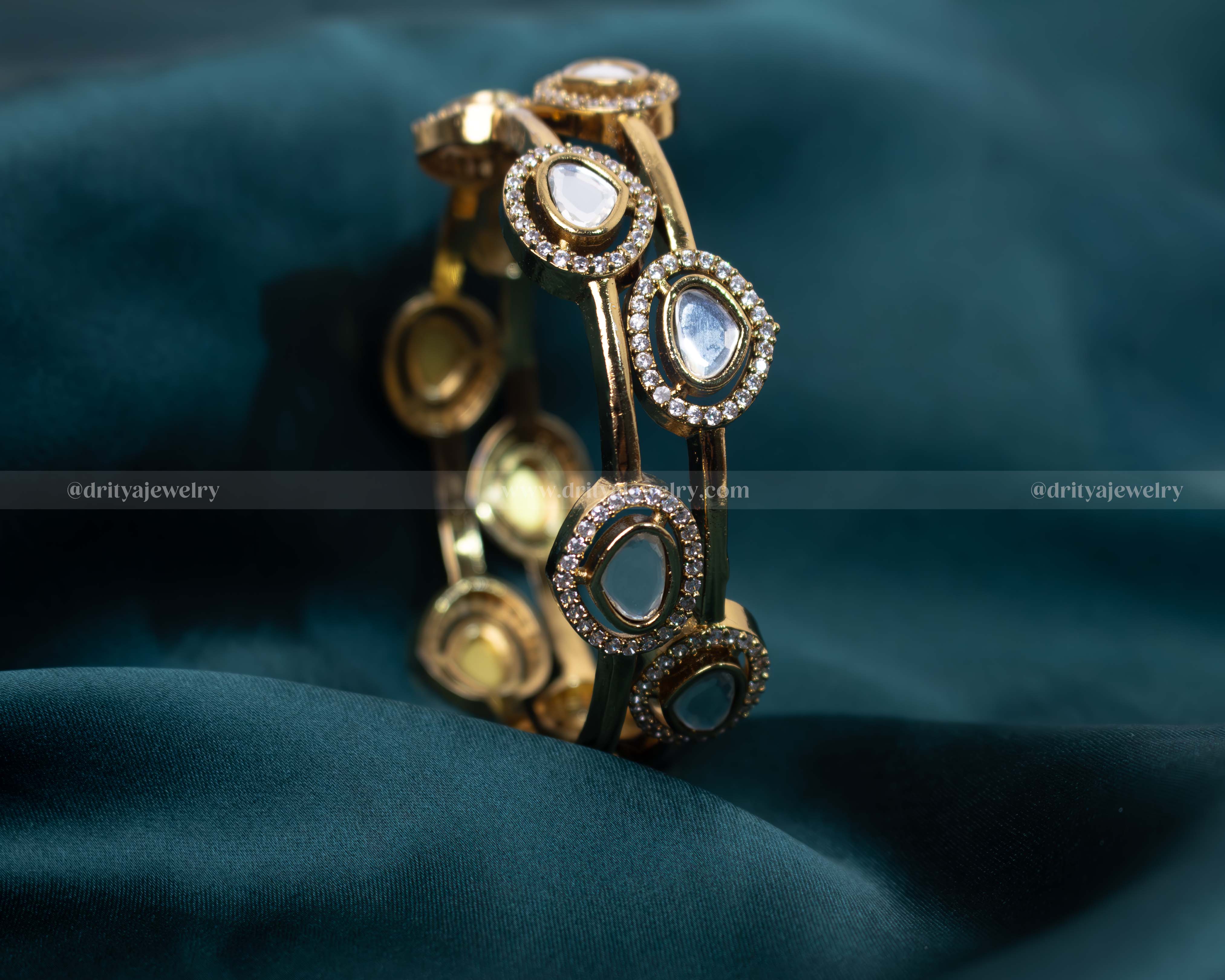 Elegant stone kada with high-quality cubic zirconia set in a polished golden frame, ideal for enhancing special occasion outfits.