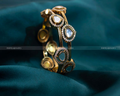 Elegant stone kada with high-quality cubic zirconia set in a polished golden frame, ideal for enhancing special occasion outfits.