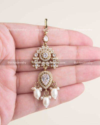 Russian emerald maang tikka with AD stones, floral motif, and Victorian gold polish.