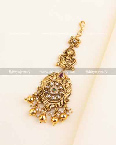 Maang tikka with Lakshmi figure and floral Kundan centerpiece with pearl hangings
