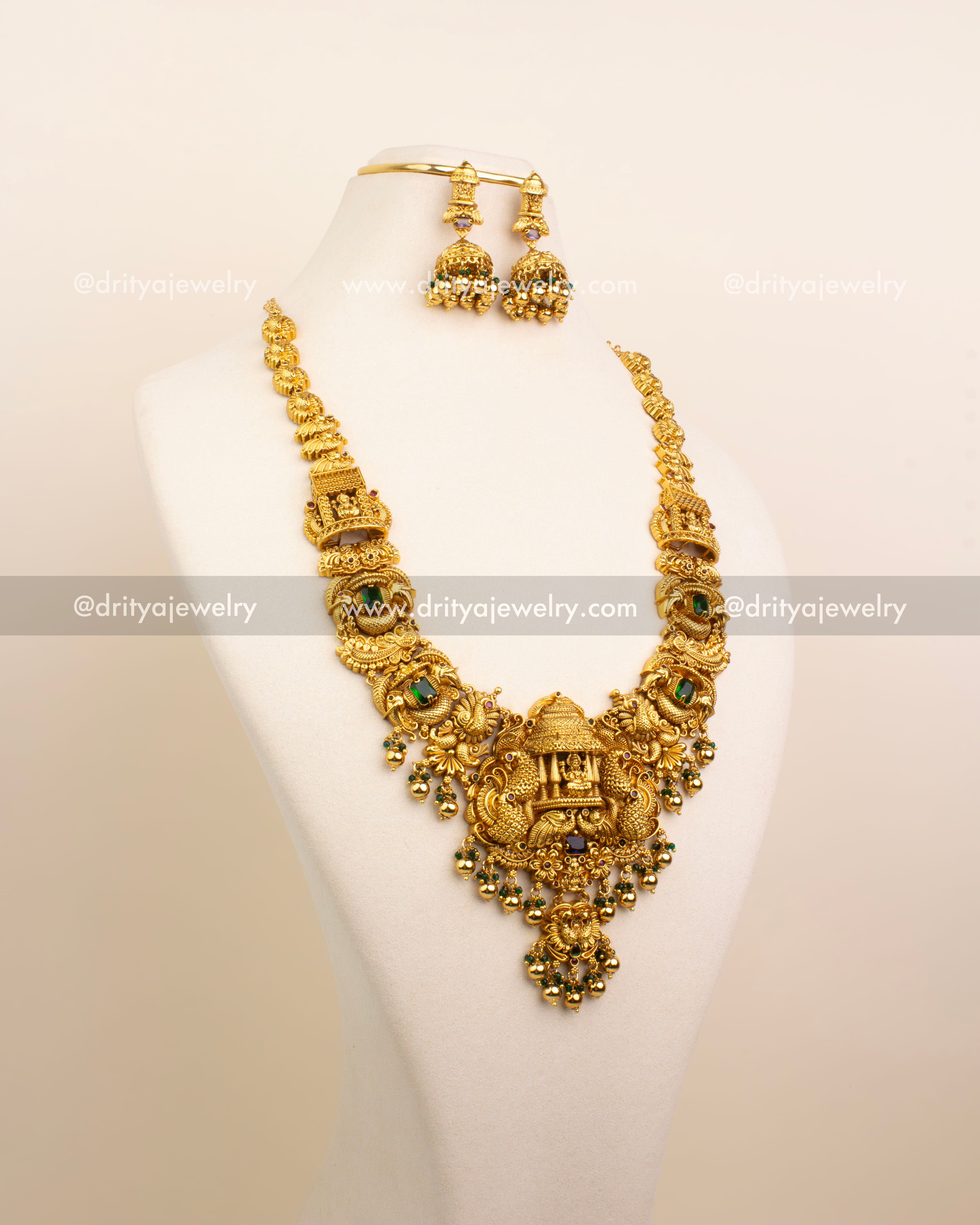 Full view of Nakshi Temple Long Necklace Set with jhumkas on bust – antique gold with green and purple accents
