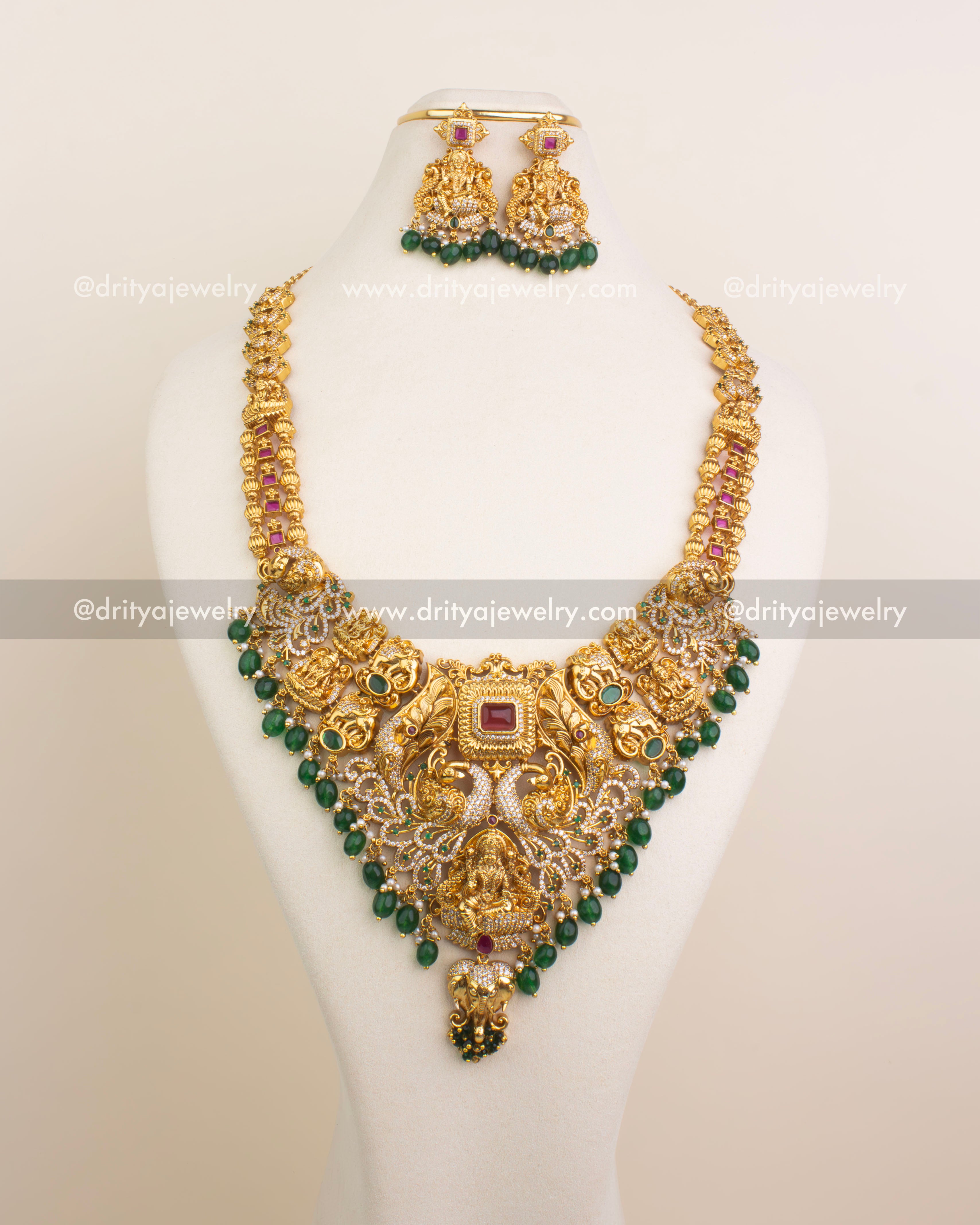 Full bridal necklace set featuring Lakshmi Devi pendant, peacock detailing, and matching earrings.