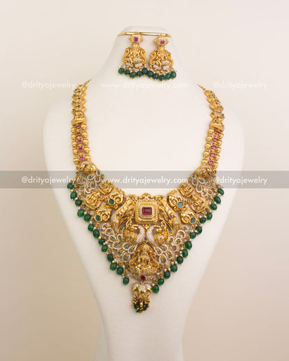 Full bridal necklace set featuring Lakshmi Devi pendant, peacock detailing, and matching earrings.