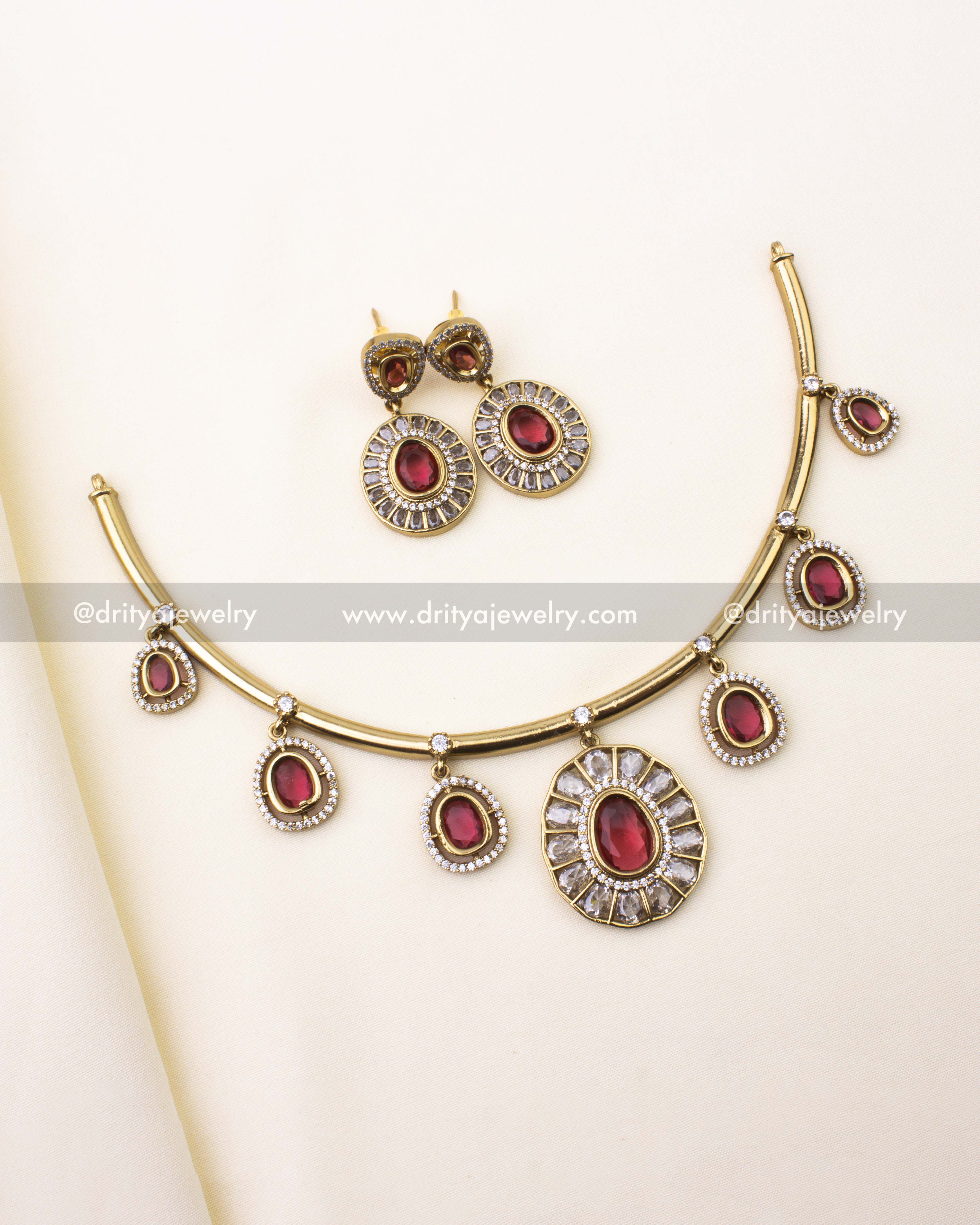 Full view of red Hasli necklace set with earrings on ivory background
