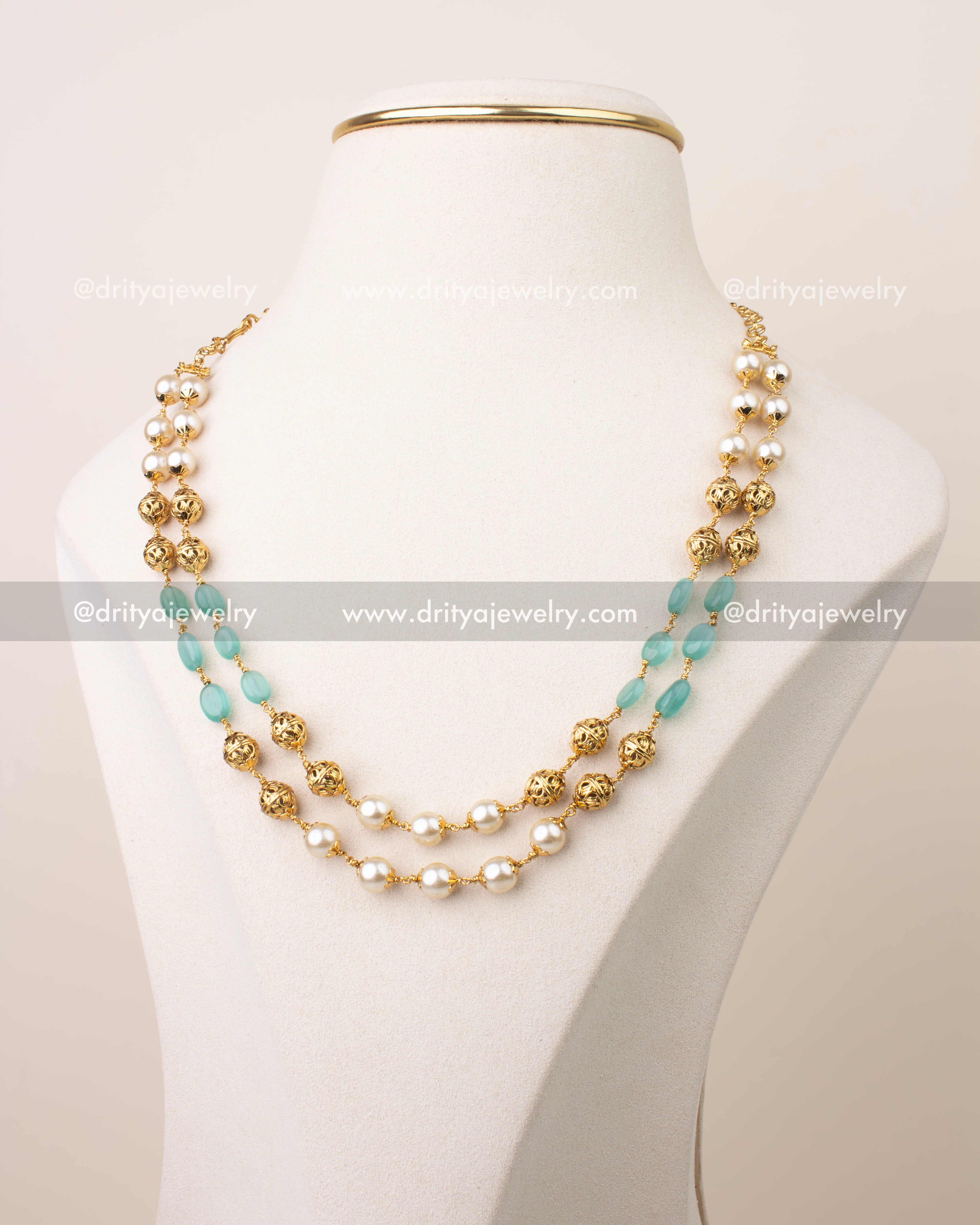 Double layer mala necklace with mint green beads, pearl accents, and gold filigree balls