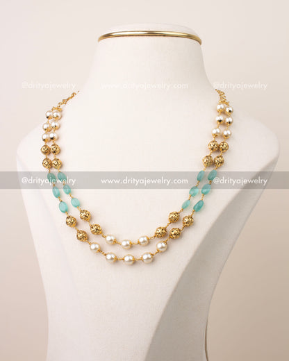 Double layer mala necklace with mint green beads, pearl accents, and gold filigree balls