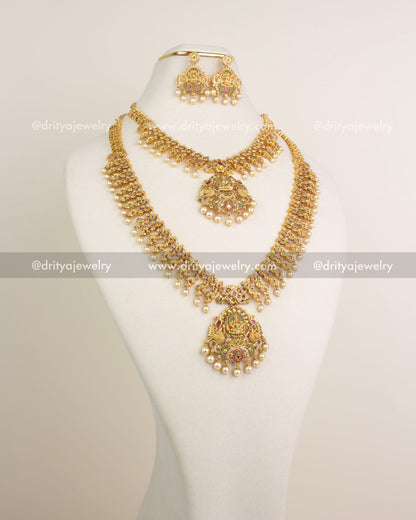 Long necklace, short necklace, earrings and maang tikka temple set in antique gold.