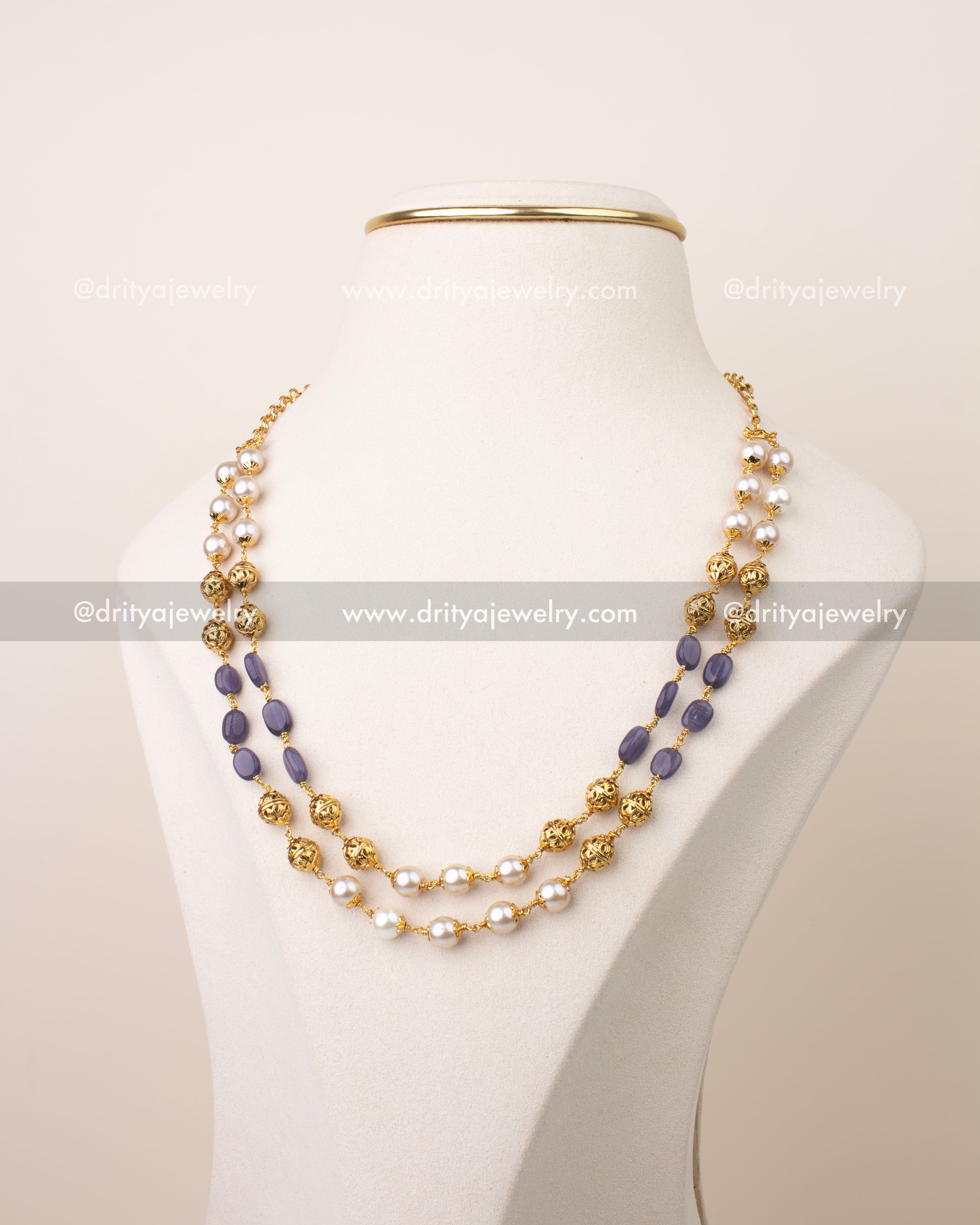 Double layer mala necklace with purple beads, pearl detailing, and gold filigree accents