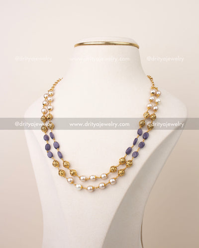 Double layer mala necklace with purple beads, pearl detailing, and gold filigree accents