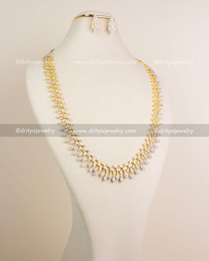 Long diamond replica necklace set in GJ polish with matching earrings displayed on mannequin.