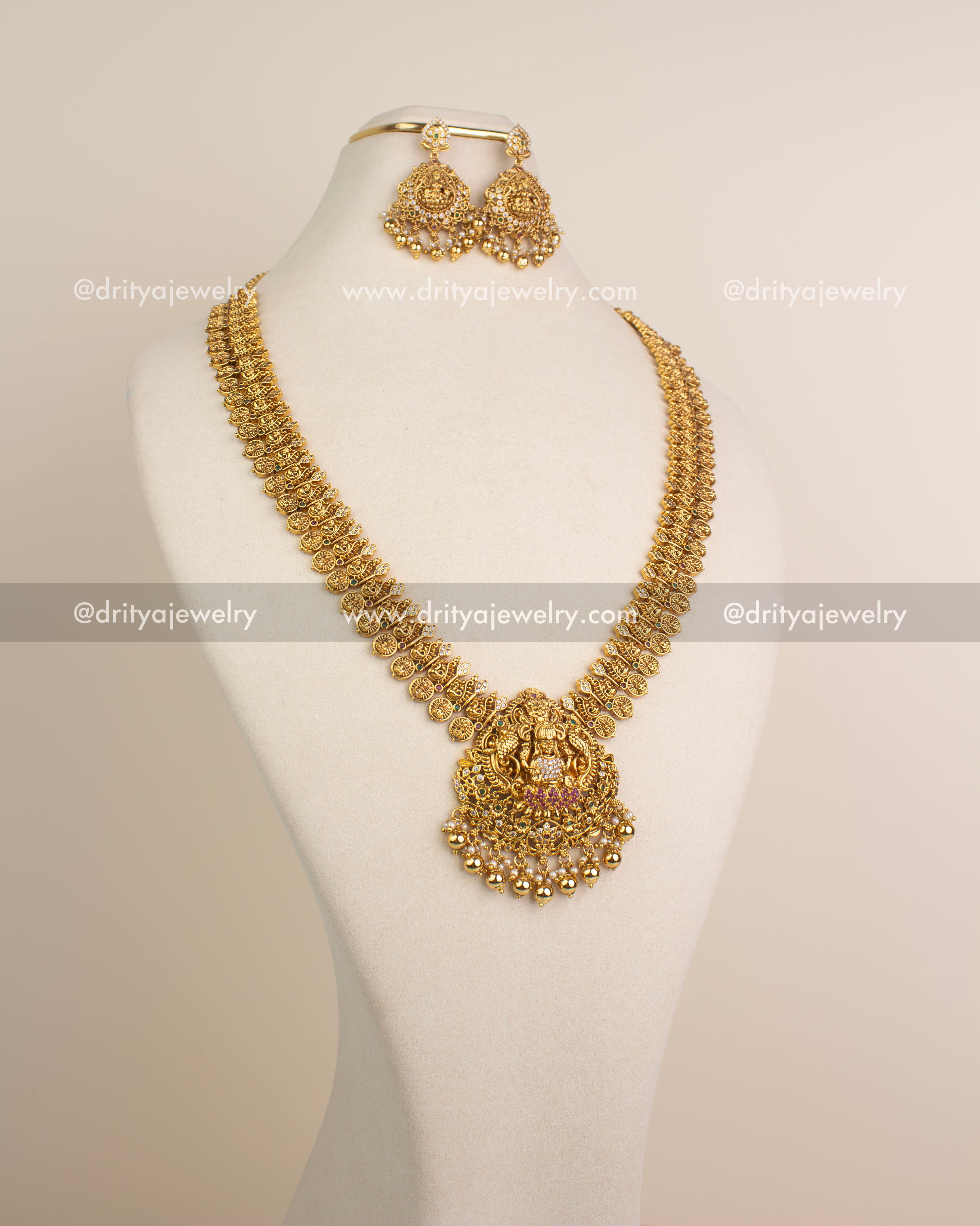 Traditional gold polish temple long necklace with Lakshmi pendant displayed on mannequin.