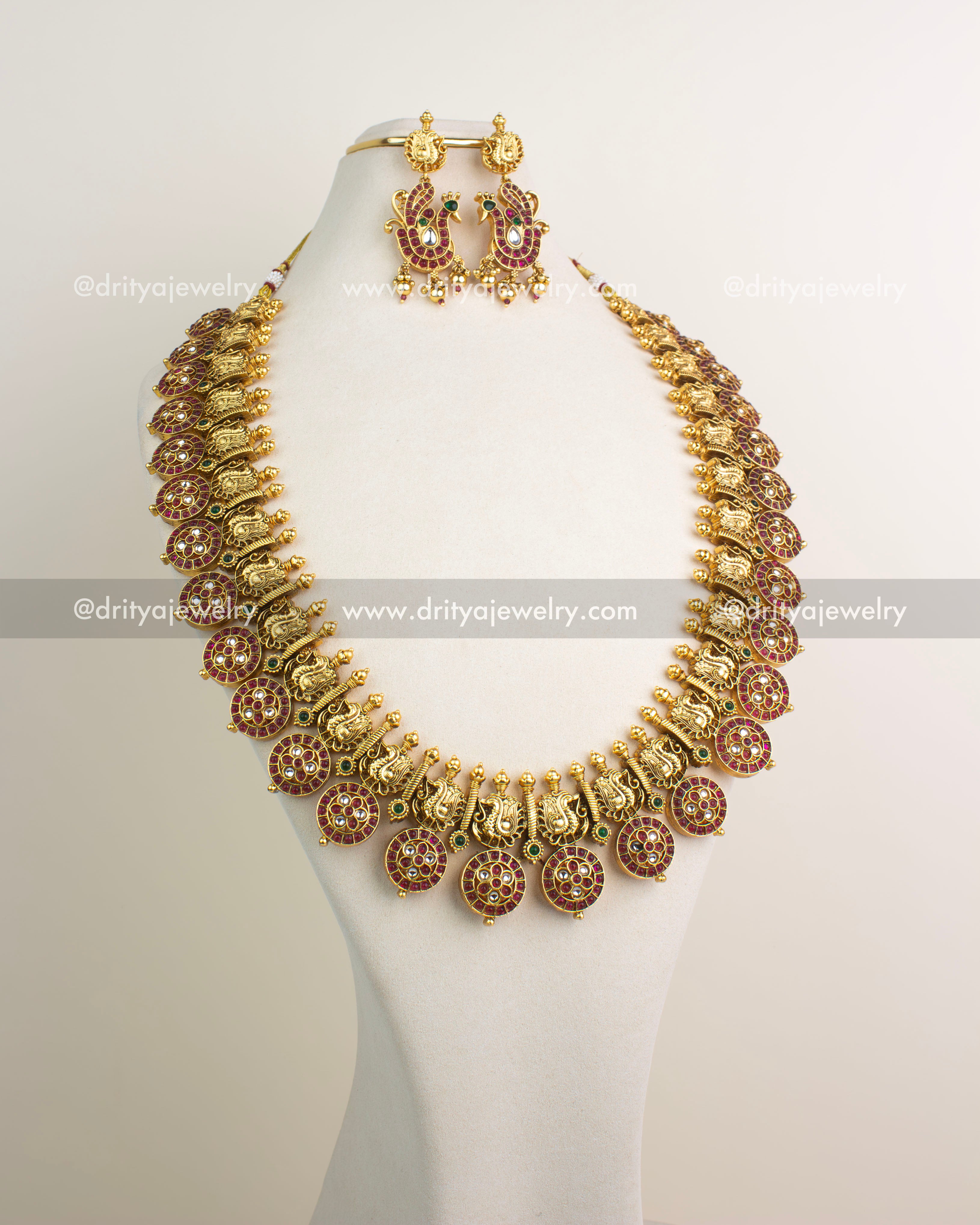 Bottu Mala long necklace with antique gold finish, polki kundan stones, ruby Bottu motifs, and matching earrings.